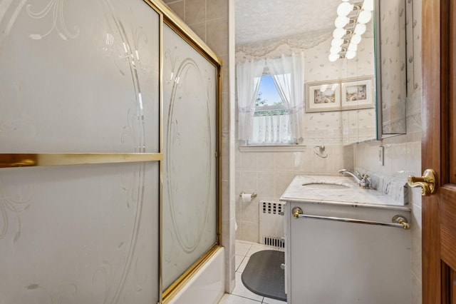 73 Spruce Ave, Floral Park, NY 11001 - full bathroom with radiator, vanity, tile walls, enclosed tub / shower combo, and tile patterned floors