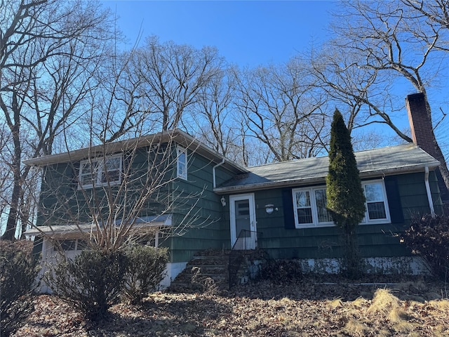 split level home featuring a chimney