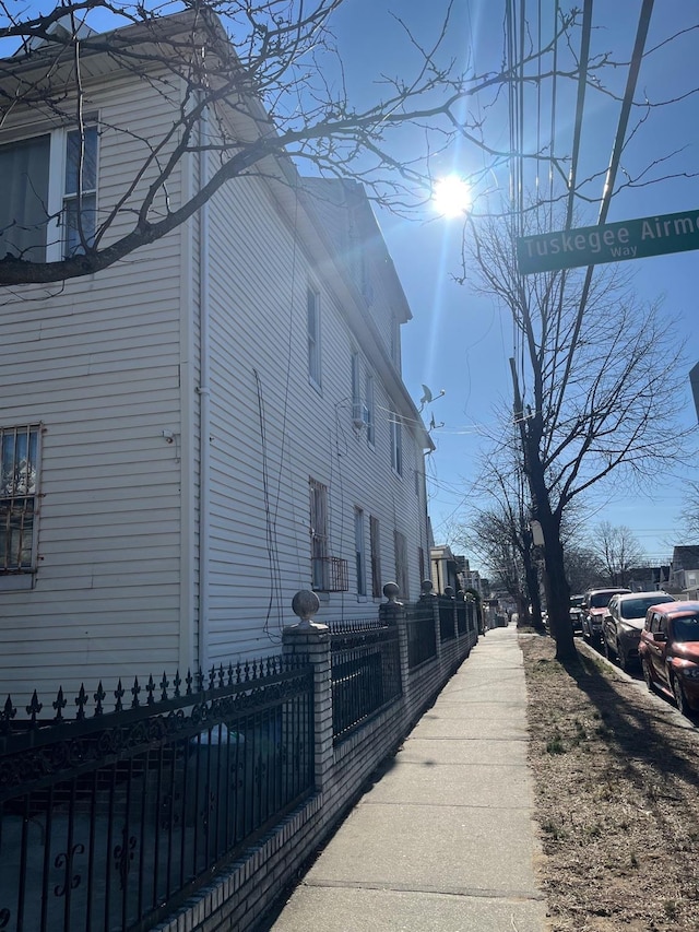 view of side of home featuring fence