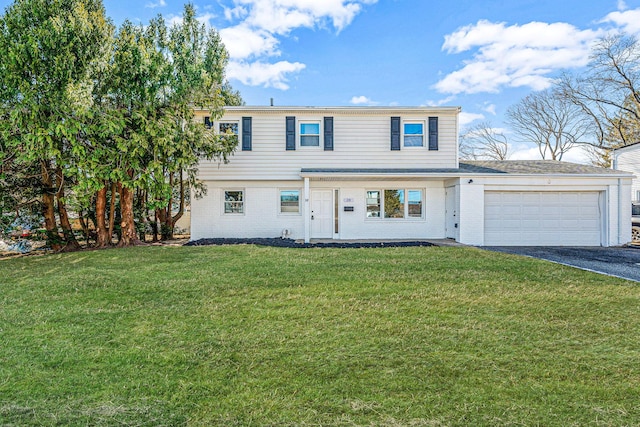 view of front of house with brick siding, aphalt driveway, a garage, and a front lawn