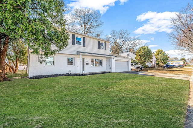 colonial-style house featuring aphalt driveway, an attached garage, a front lawn, and brick siding