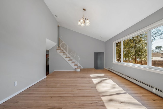 unfurnished living room featuring a baseboard heating unit, light wood finished floors, an inviting chandelier, and stairway