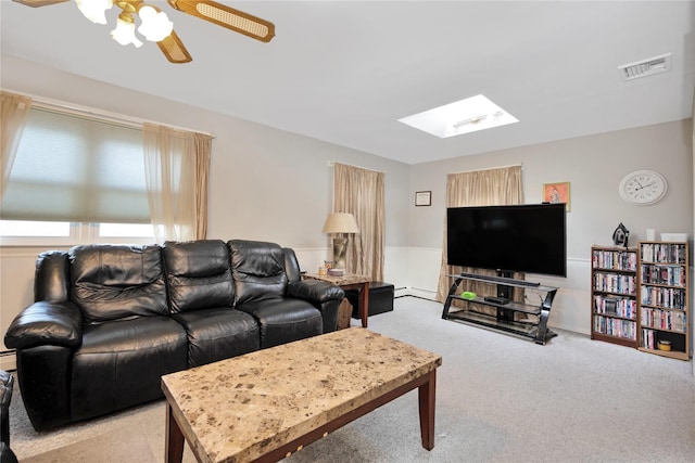 carpeted living area with a skylight, visible vents, and ceiling fan