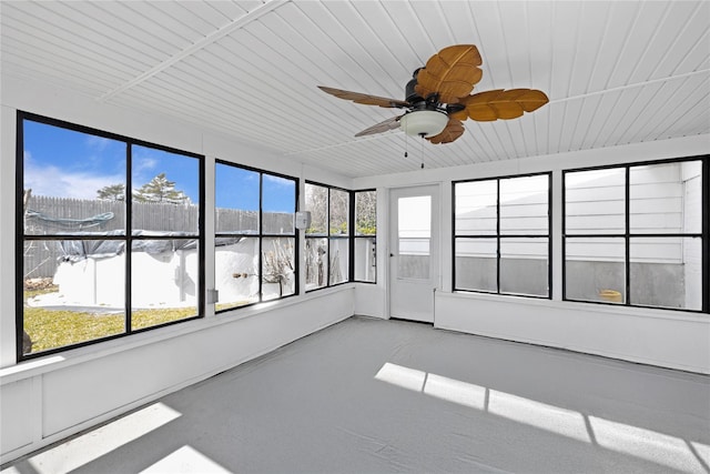 unfurnished sunroom featuring a ceiling fan