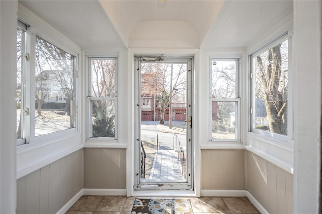 unfurnished sunroom with vaulted ceiling