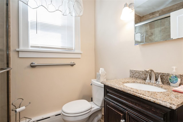 full bathroom with a shower with shower door, toilet, and vanity