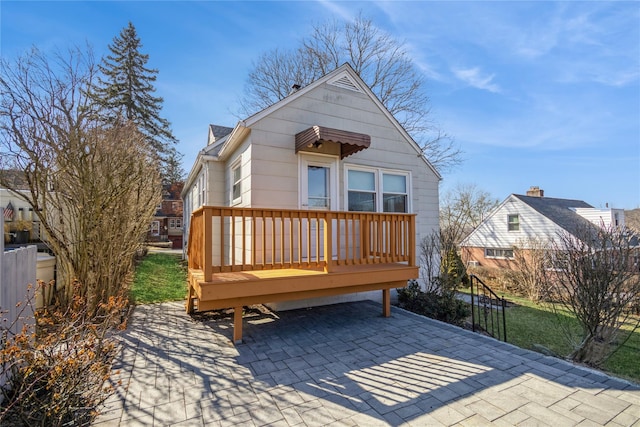 rear view of property featuring a patio area and fence