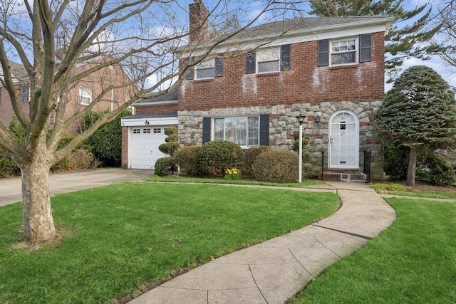 view of front of home featuring concrete driveway, a front yard, stone siding, and a chimney