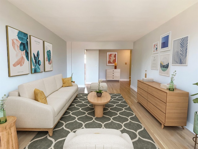 living area with light wood-type flooring and baseboards