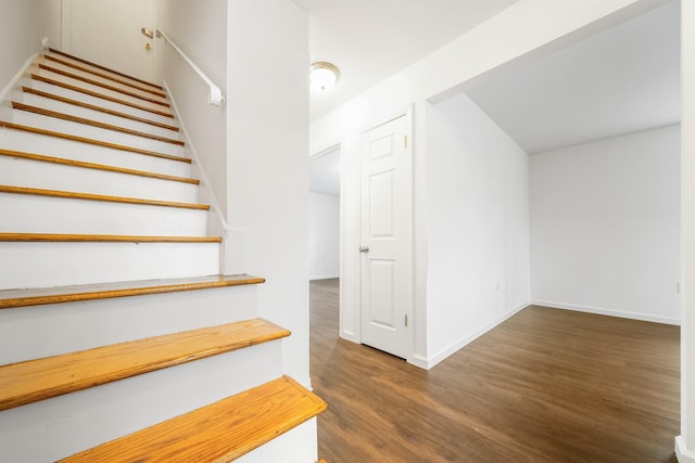 stairs featuring baseboards and wood finished floors