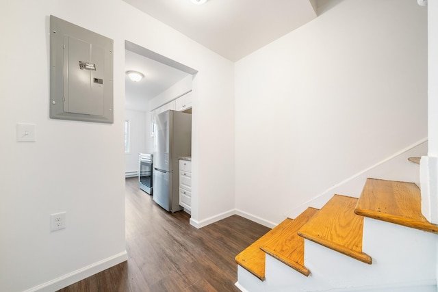 stairs with electric panel, baseboards, and wood finished floors