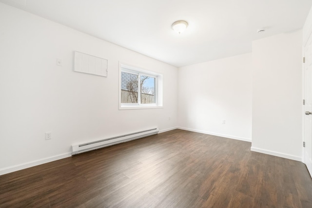 unfurnished room with dark wood-type flooring, baseboards, and a baseboard radiator