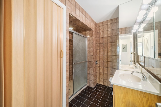 full bath featuring a sink, tile walls, and tile patterned floors