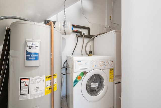 laundry room with washer / clothes dryer, water heater, and laundry area