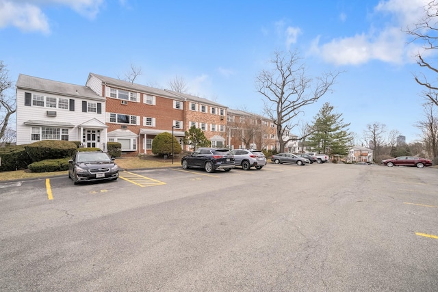 uncovered parking lot featuring a residential view