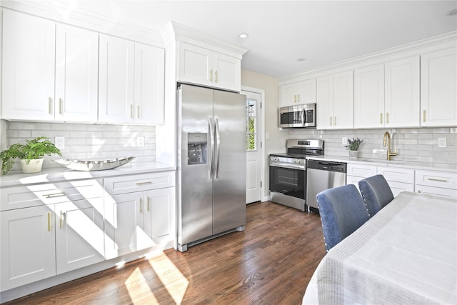 kitchen with white cabinetry, light countertops, dark wood finished floors, and stainless steel appliances