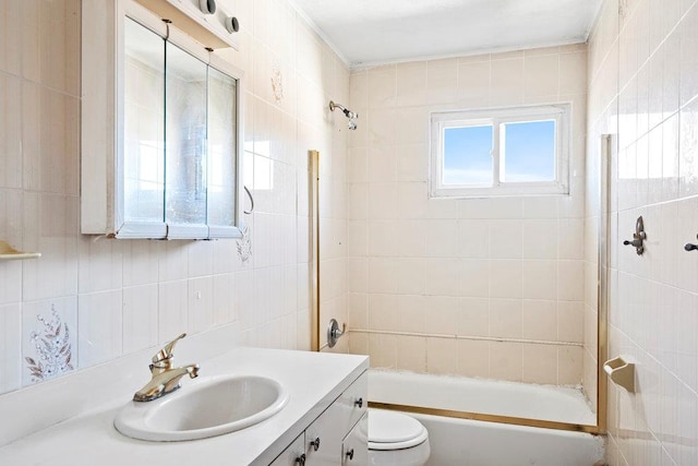 full bathroom featuring vanity, tile walls, toilet, and shower / bath combination