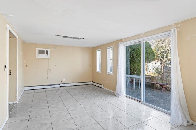 spare room featuring baseboard heating and an AC wall unit