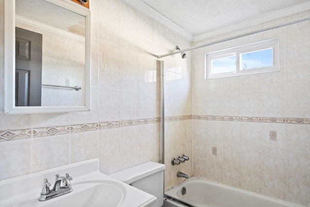 full bath with tile walls, toilet, ornamental molding, bathtub / shower combination, and a textured ceiling