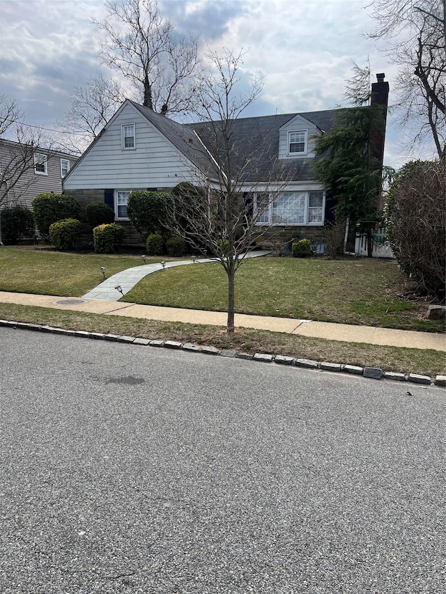 view of front of house featuring a front yard and a chimney