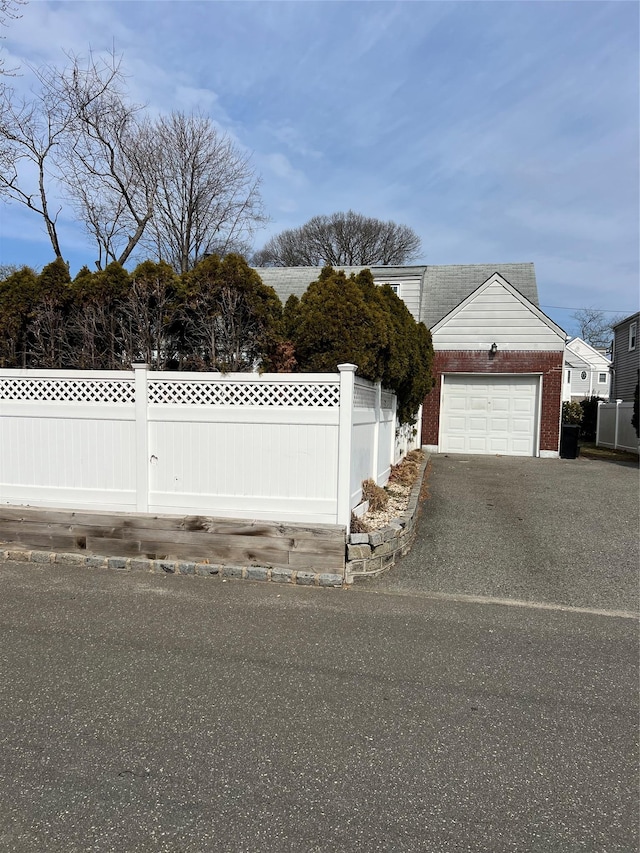 exterior space with brick siding and fence