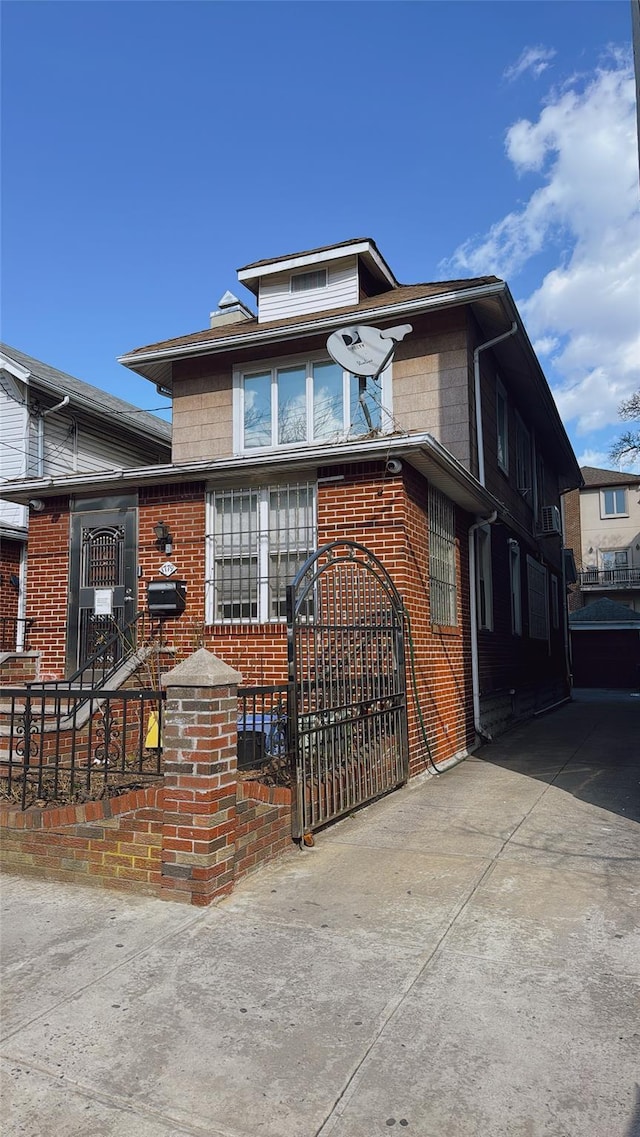 view of front of house with brick siding and driveway