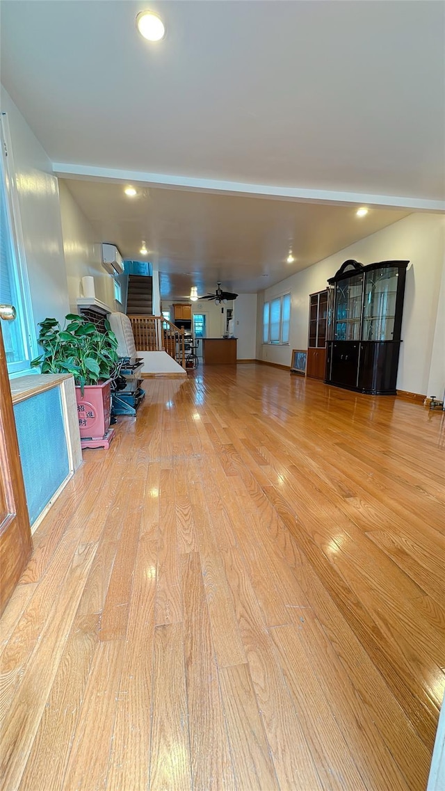 interior space with recessed lighting, a ceiling fan, and wood finished floors