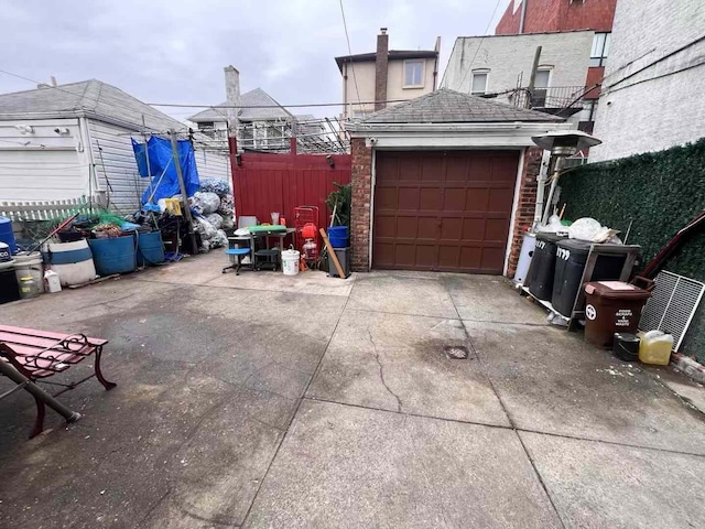 garage with fence and driveway