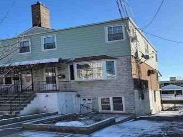 rear view of property with a chimney