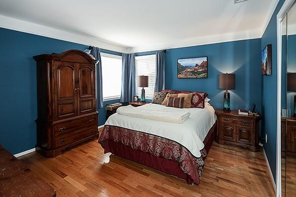 bedroom featuring wood finished floors and baseboards