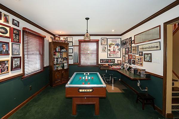 rec room featuring baseboards, carpet floors, and ornamental molding