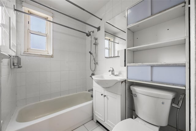 bathroom with toilet, vanity, and shower / tub combination