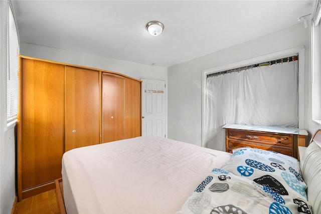 bedroom featuring a closet and wood finished floors