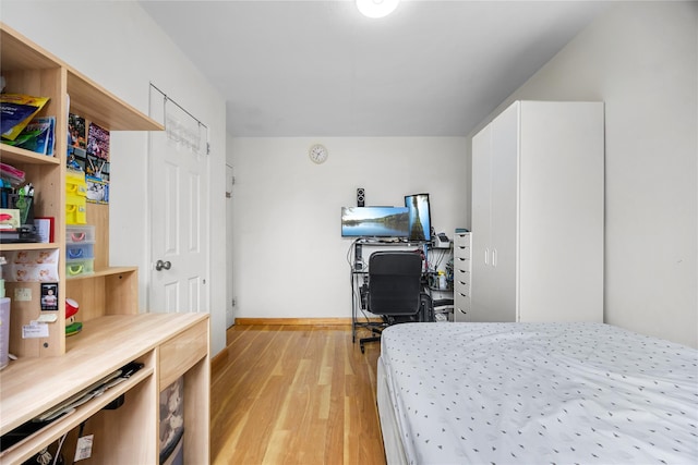 bedroom featuring light wood-style flooring and baseboards