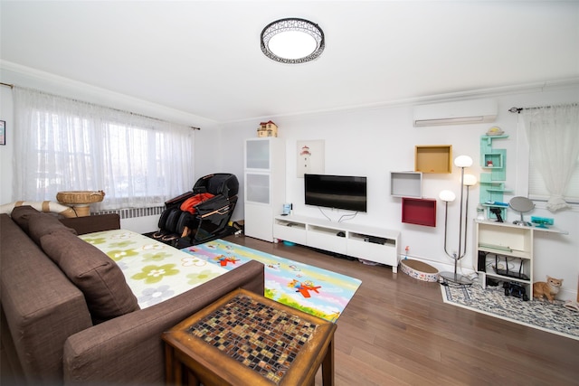 living area featuring ornamental molding, a wall mounted air conditioner, baseboards, and wood finished floors