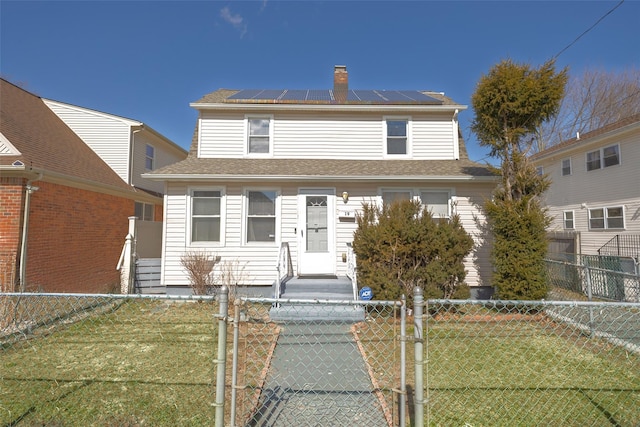 view of front of home with entry steps, a gate, roof mounted solar panels, and a fenced front yard