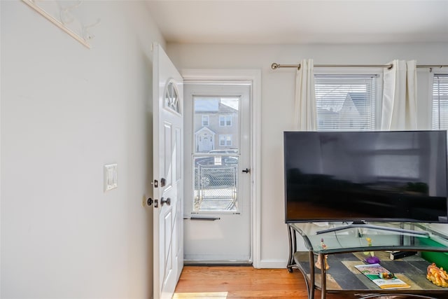 entryway with baseboards and light wood-style floors