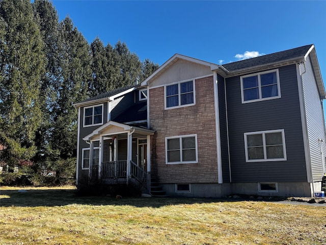 view of front of house featuring stone siding and a front yard