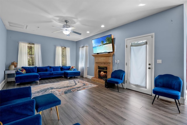 441 County Route 48, Thompson Ridge, NY 10985 - living area featuring visible vents, baseboards, ceiling fan, a warm lit fireplace, and wood finished floors