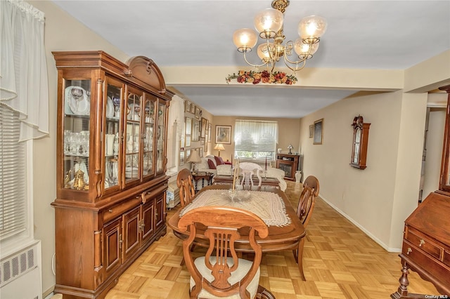 dining area with an inviting chandelier, radiator, and baseboards