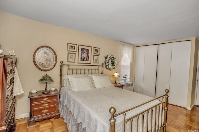 bedroom featuring radiator, baseboards, and a closet