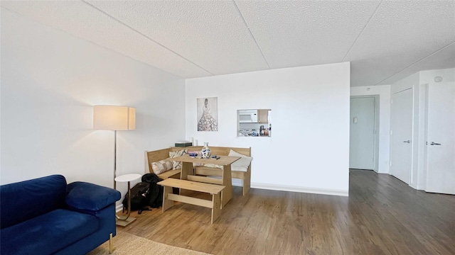 sitting room with wood finished floors and a textured ceiling