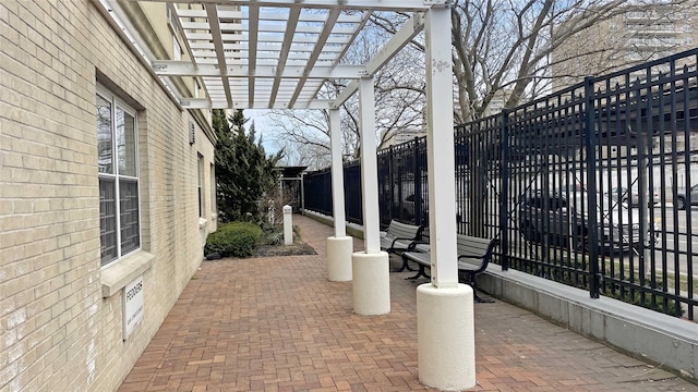 view of patio featuring a pergola and fence