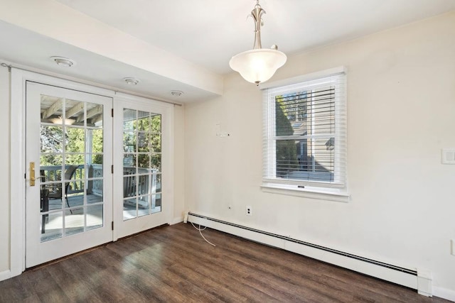 unfurnished dining area featuring baseboard heating and wood finished floors