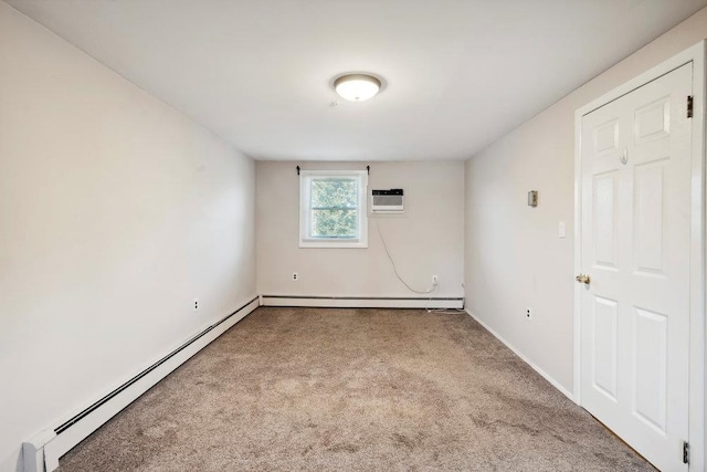 spare room with a baseboard heating unit, baseboards, and carpet floors