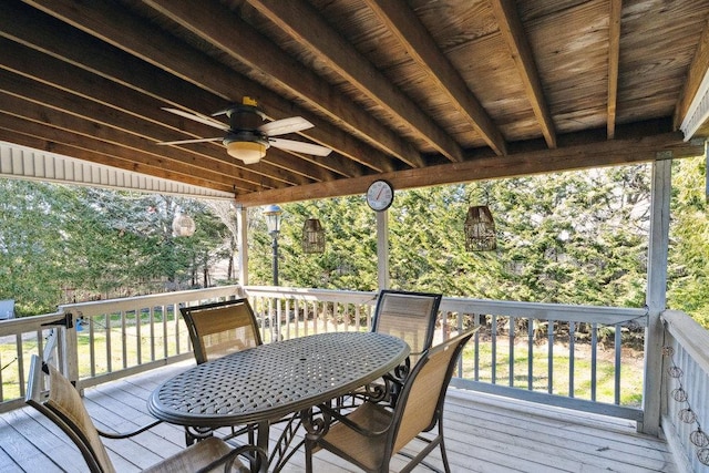 wooden deck featuring outdoor dining area and ceiling fan