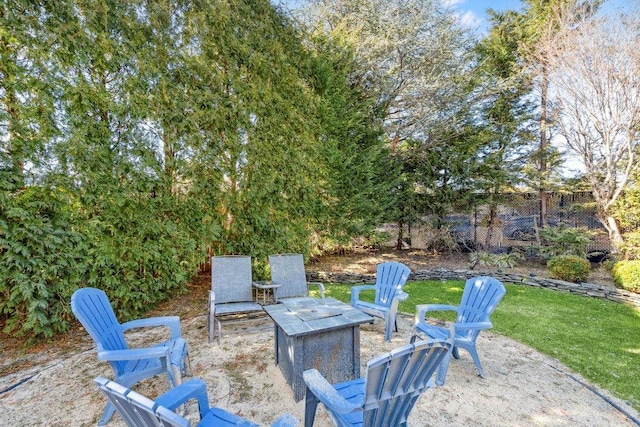 view of patio featuring a fire pit and fence