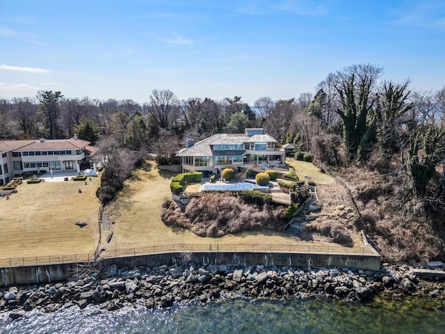 drone / aerial view featuring a water view and a view of trees
