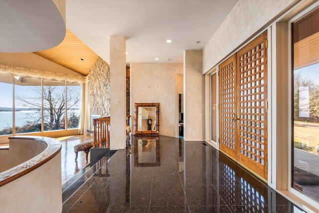 corridor featuring granite finish floor and recessed lighting