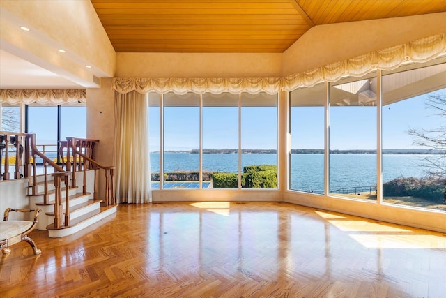 unfurnished sunroom with a water view